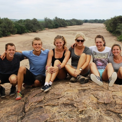 Conservation group volunteer work in Botswana Projects Abroad wildlife conservation volunteering group in Botswana sitting on top of a hill